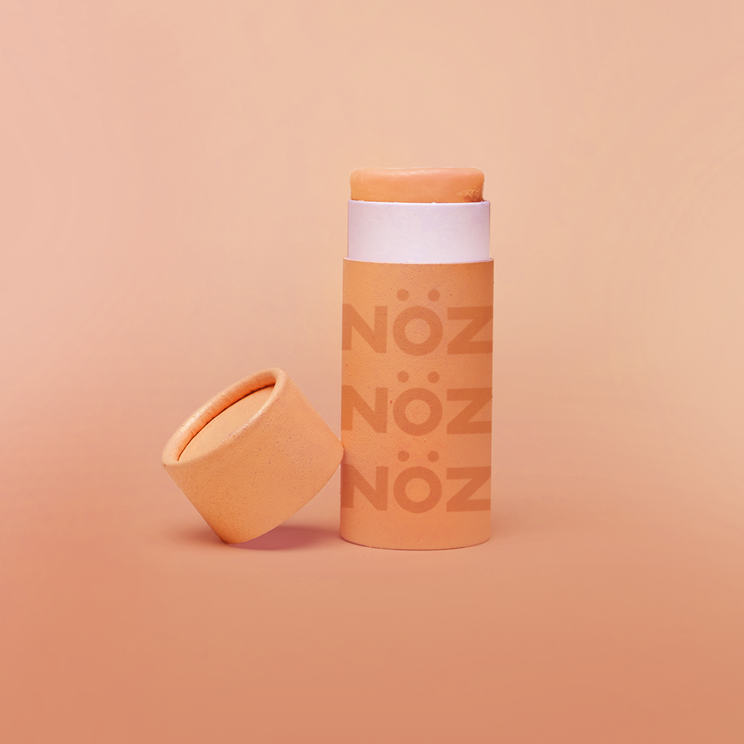 Nöz sunscreen tube with the lid off in shade orange.