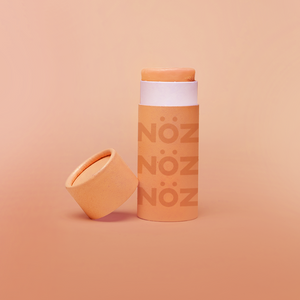 Nöz sunscreen tube with the lid off in shade orange.